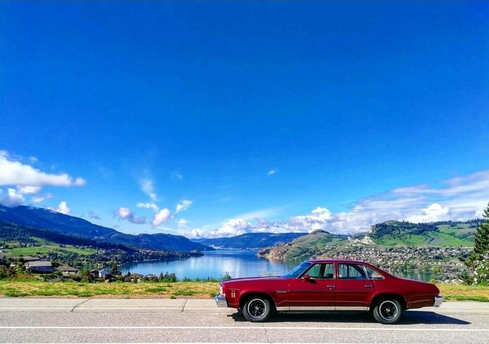 My cranberry red'73 Chevelle Malibu in a sunny day with Kalamalka Lake B.C. ("The Lake") in the background.