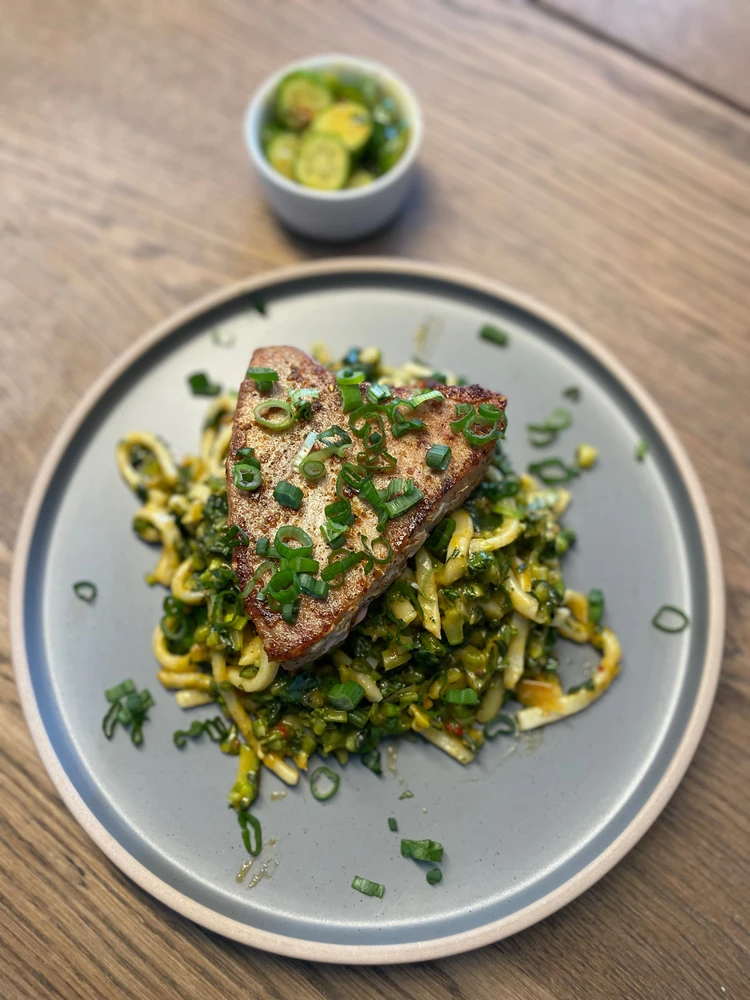 Seared Tuna to medium rare on top of buttered udon, mixed with Gai lan and kimchi, garnished with scallions