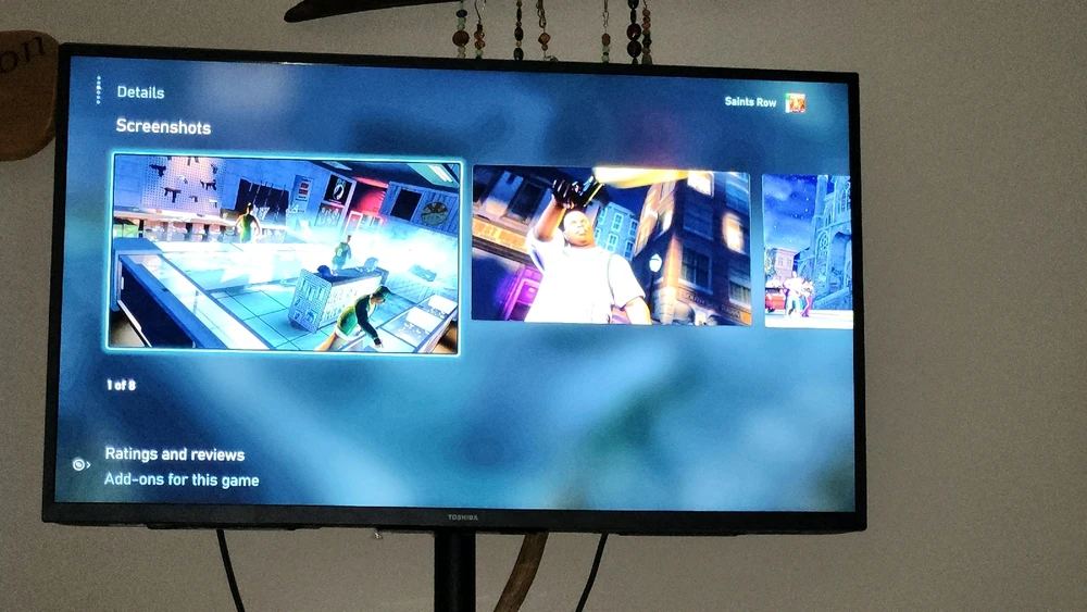 A television displaying screenshots of the video game Saints Row.