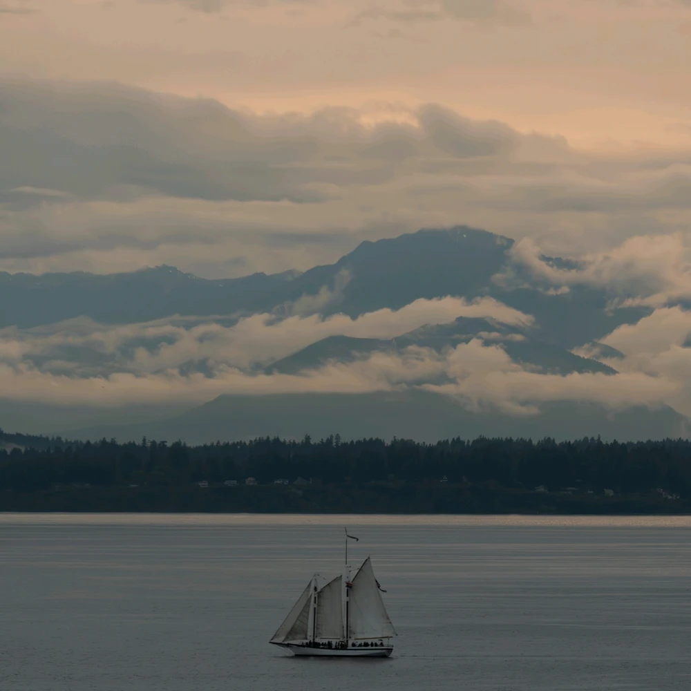 Sailboat on Puget sound with mountain in background 