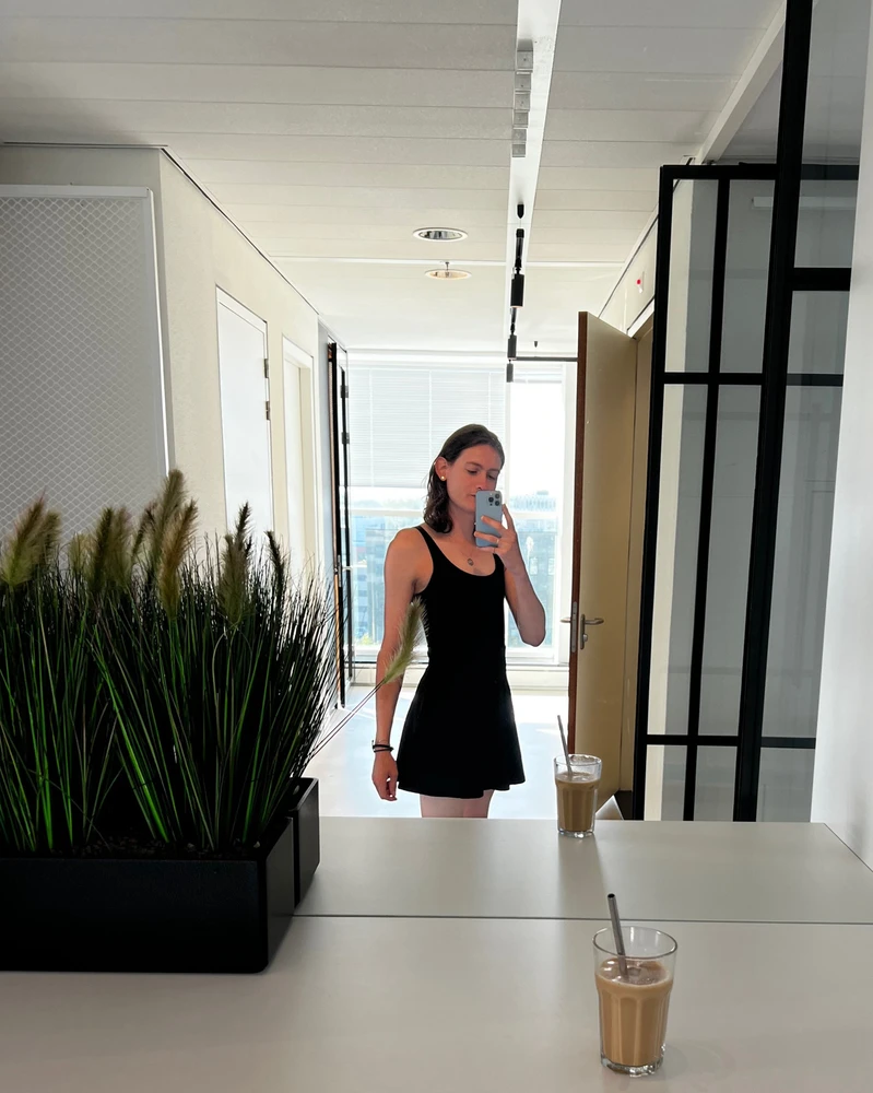 Queer person taking a mirror selfie