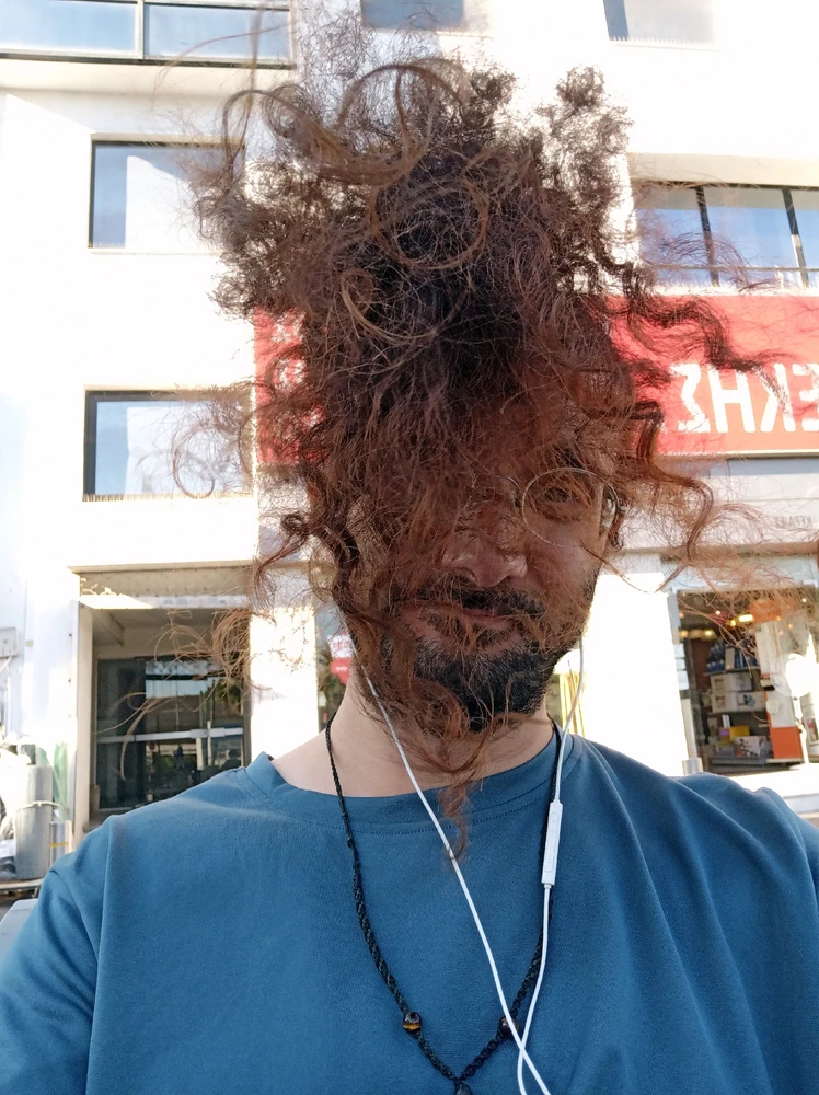I have long hair. And the wind is blowing from my backside. All of the hair was on my face in this photo.