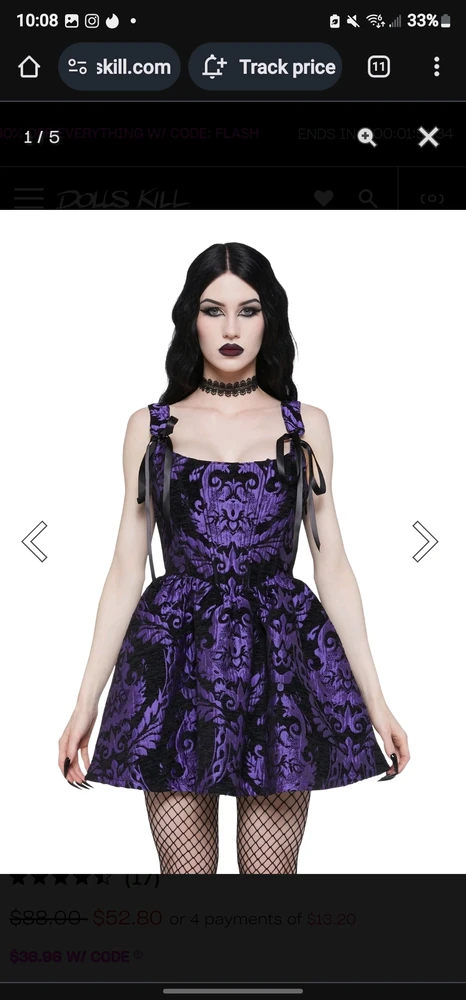 Model wears purple and black brocade dress