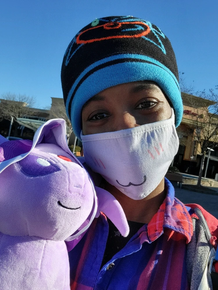 Selfie of me and a Build-A-Bear Espeon outside a mall.