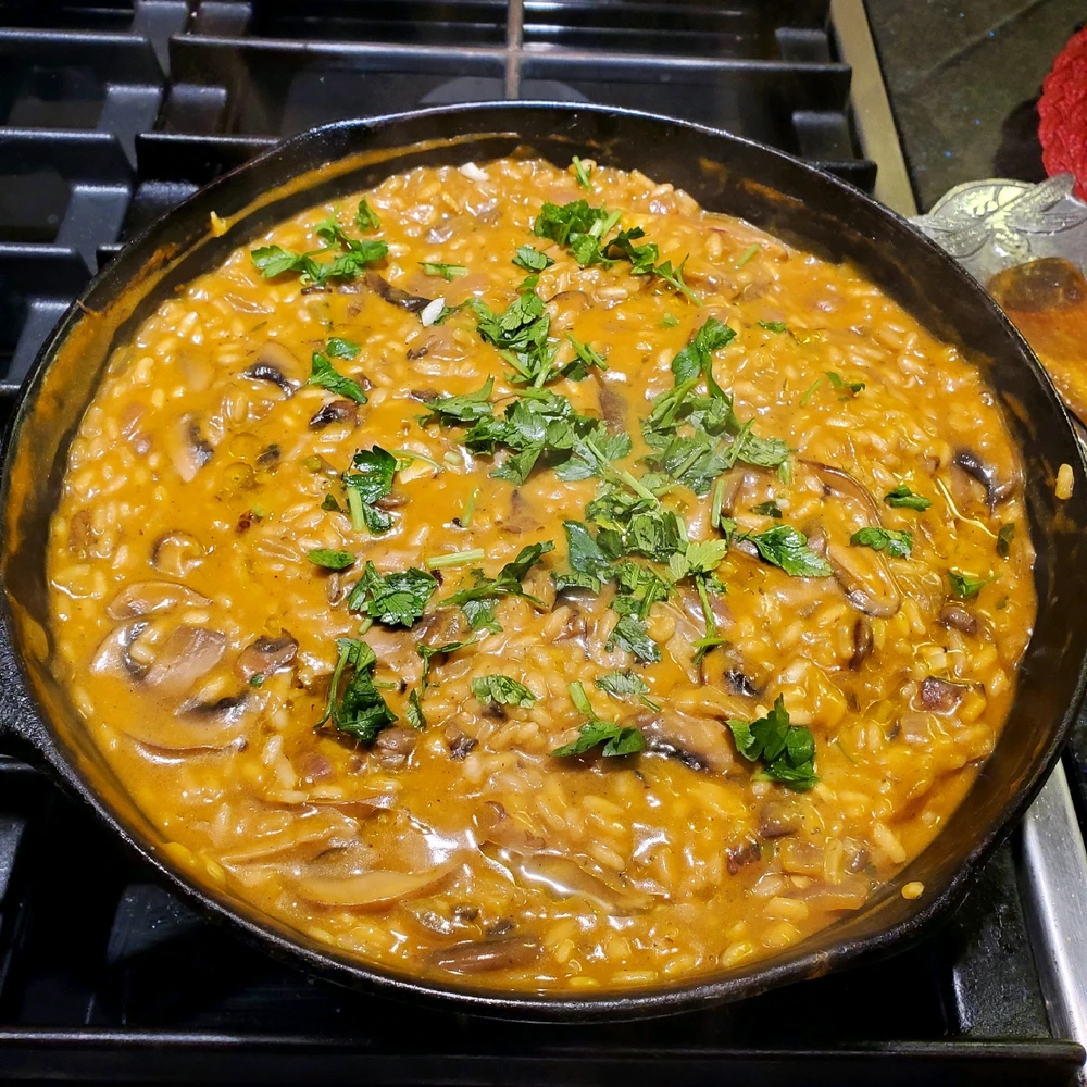 A mushroom risotto in a cast iron pan