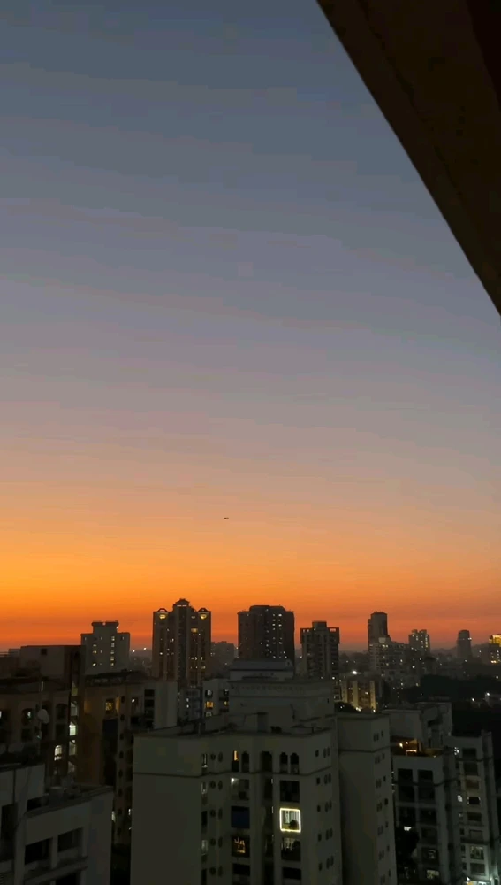 Golden sunset with city lights shining and clouds making it's way in the golden sky. 