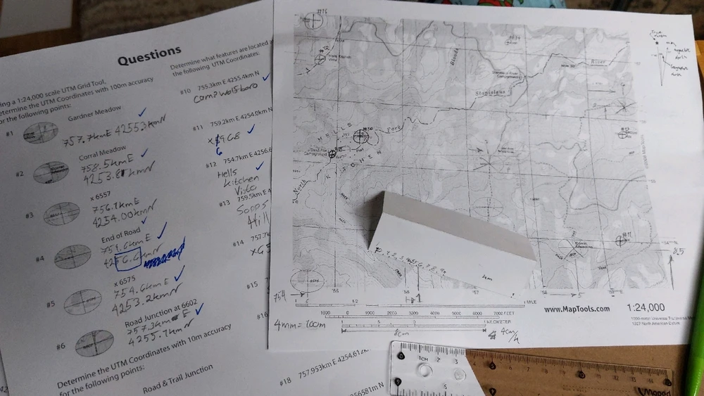 A map with UTM grid, strip of paper, straighedge, mechanical pencil and a sheet of questions 