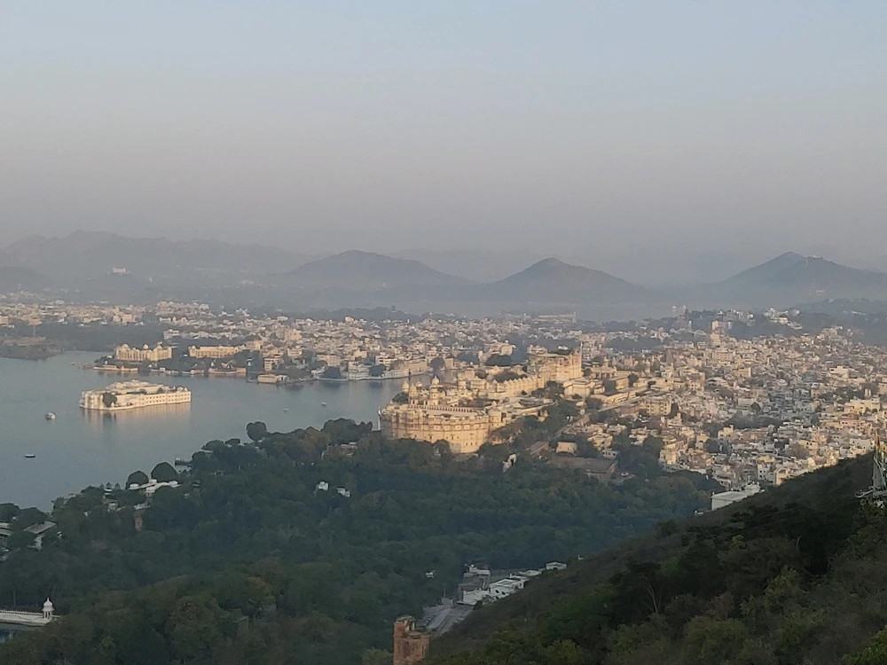 Morning view of city from the hill top consisting greenery with inhabitants