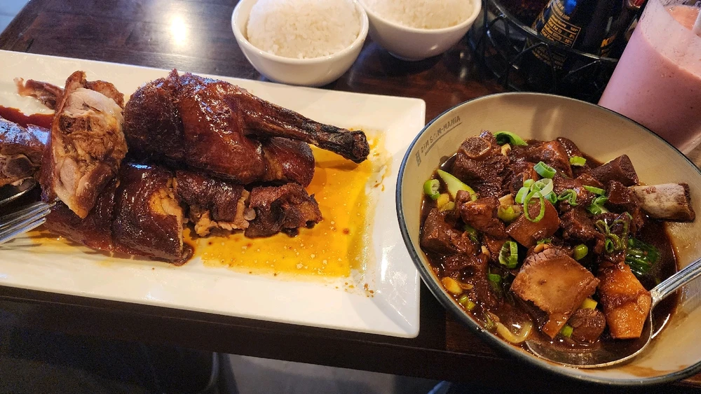 A plate of roasted duck on the left. So tender and juicy. On the right is a bowl of Shanghai ribs. Also very good 