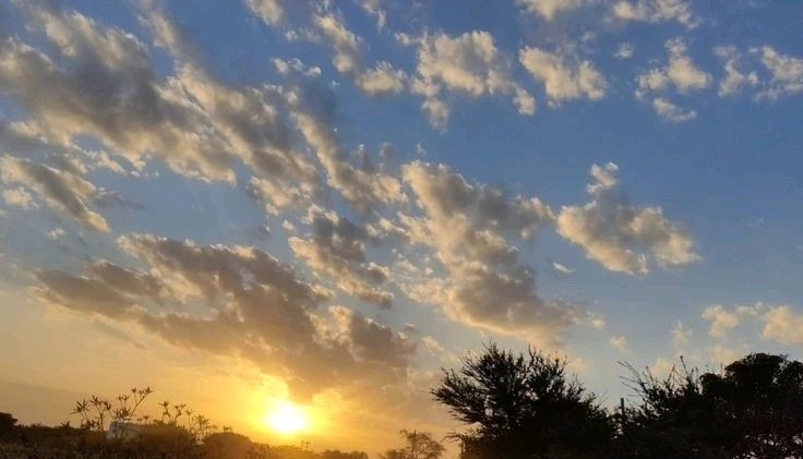 Golden sunset with clouds spread in the evening sky 