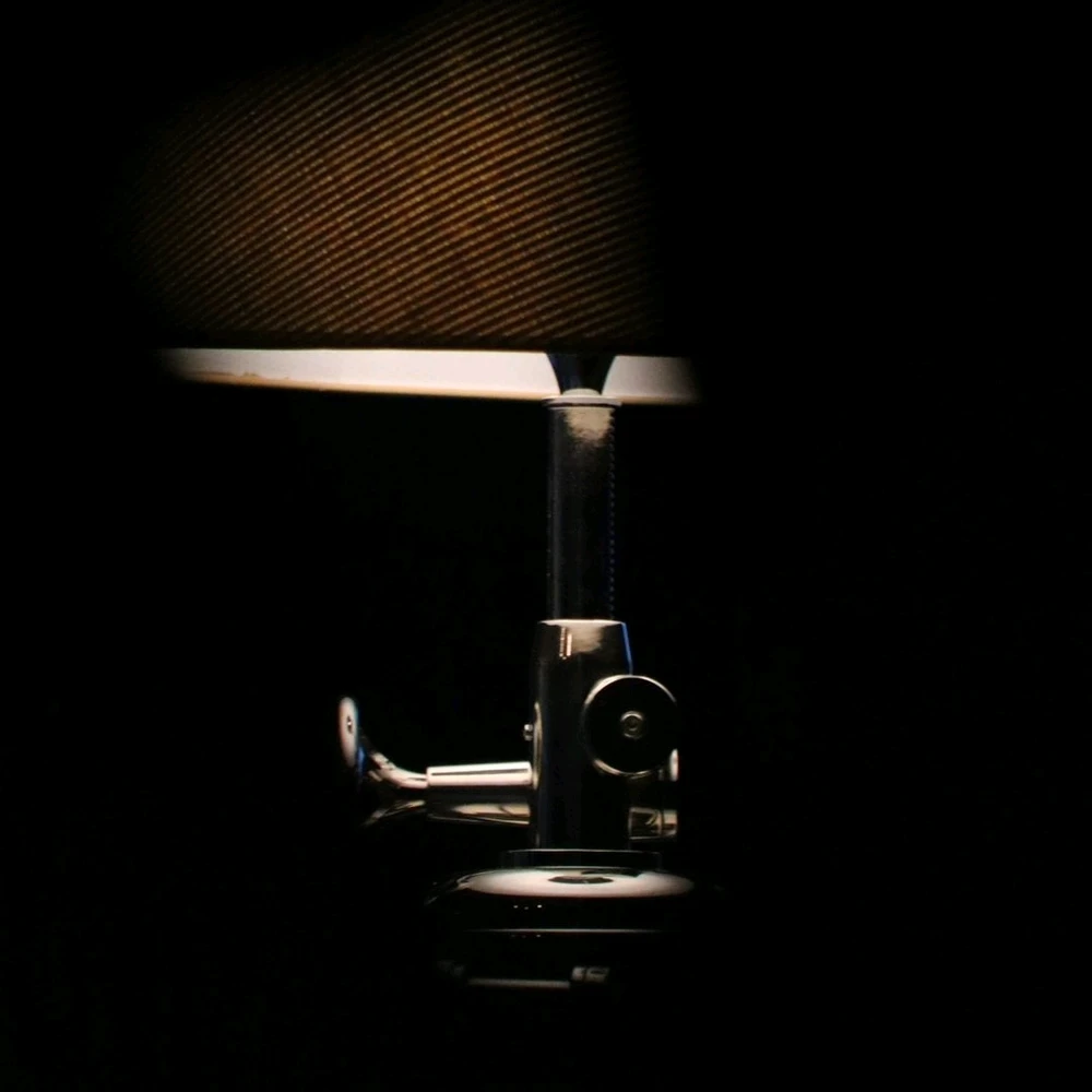 A lamp, highlighted on a too dark to see background