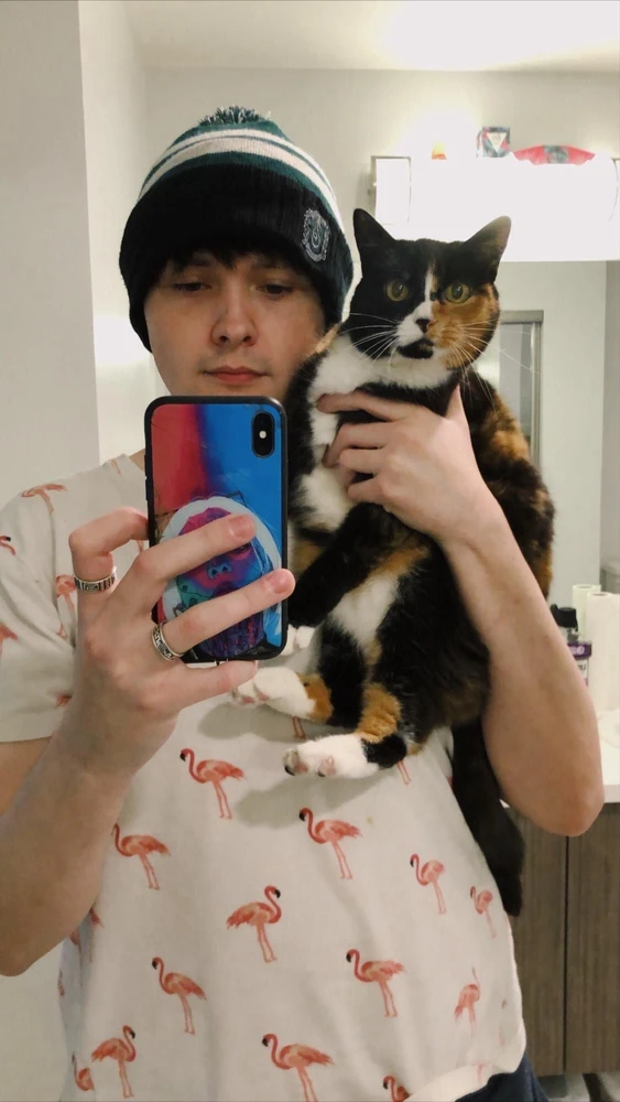 A picture of me holding my little fur baby boodles in a mirror selfie.