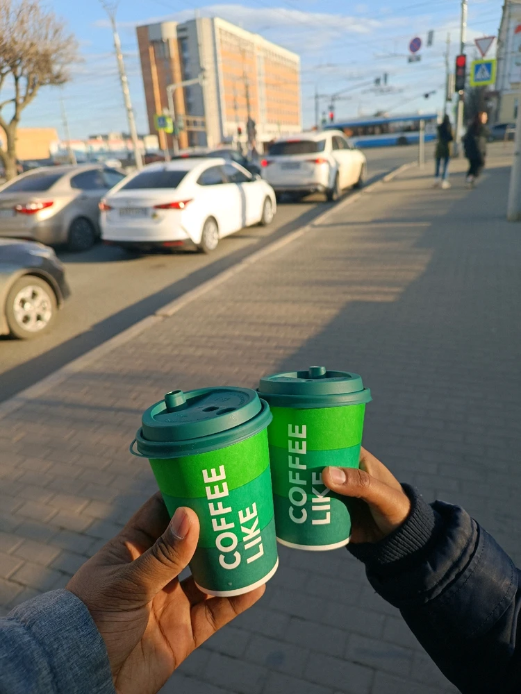 The background is a busy street in the city of Kirov in Russia , its a beautiful city , and we walk past sipping our coffee ⚡