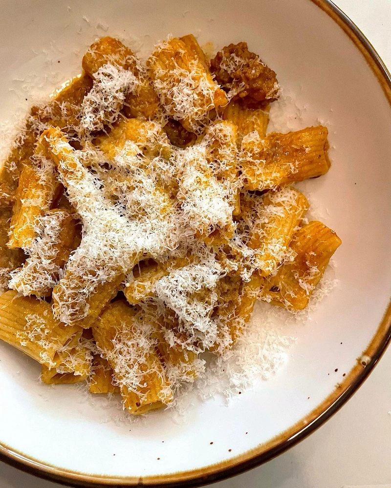House made Ragu w/ fresh extruded rigatoni and grated parmesan cheese