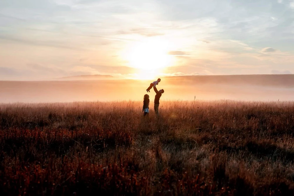 Sunrise in Oklahoma. A family of 3. A mom, dad, and their young child. If you look closely, there is an Elk on the horizon.