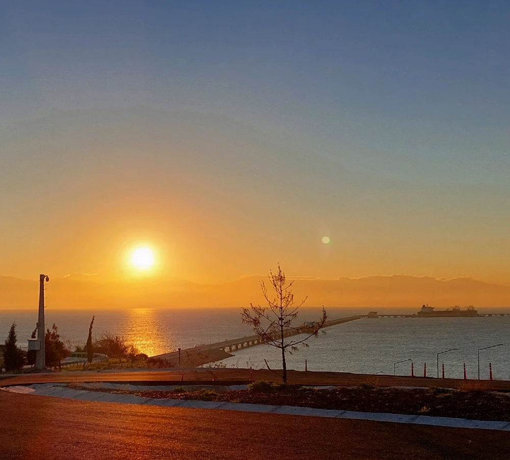 Sunset view in Adana city in Turkiye at the end of the oil pipeline jetty in Medetarrenean Sea.