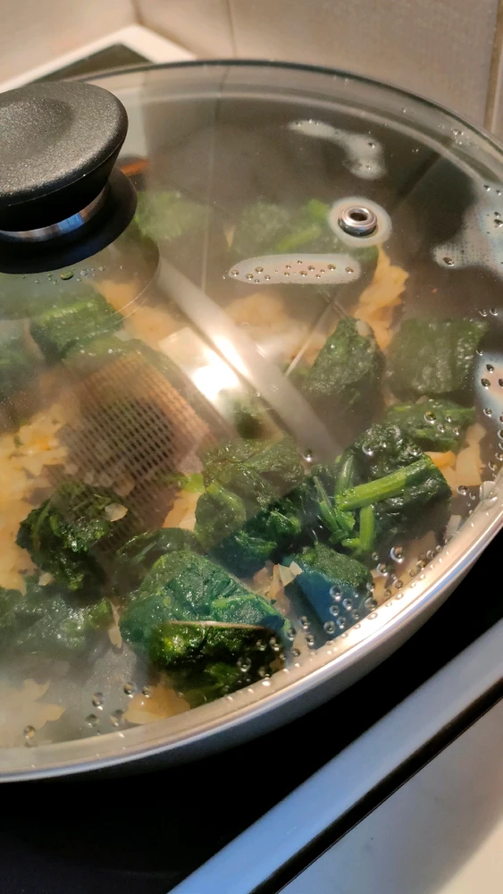 A pan with steaming spinache
