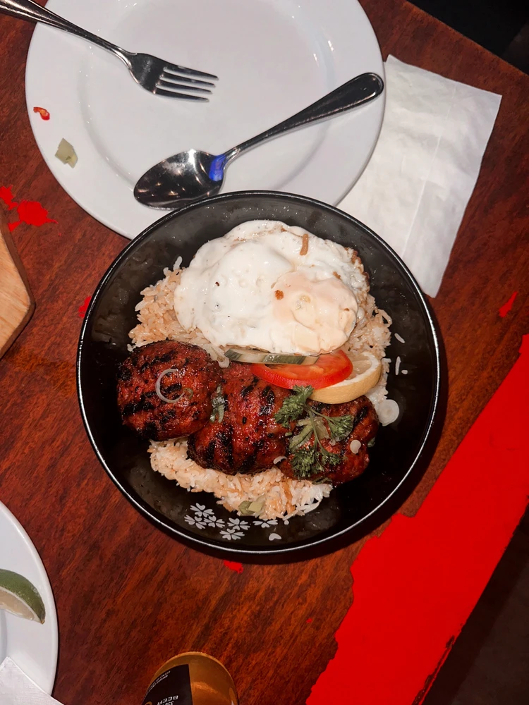 Sausage and fried rice with sunny side up egg.