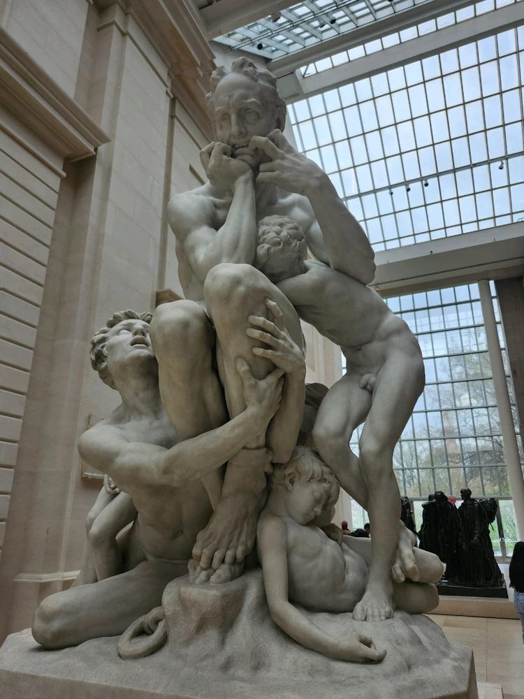 Sculpture of a father in agony, while his sons cling to him