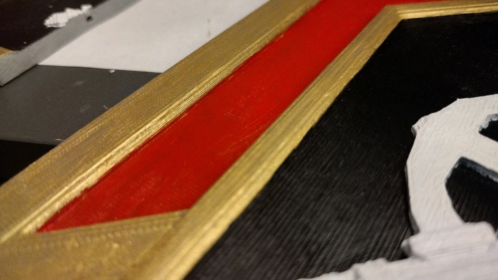 Close up of acrylic paint on a 3d print. The print lines are visible yet the paint has flowed over them smoothly.