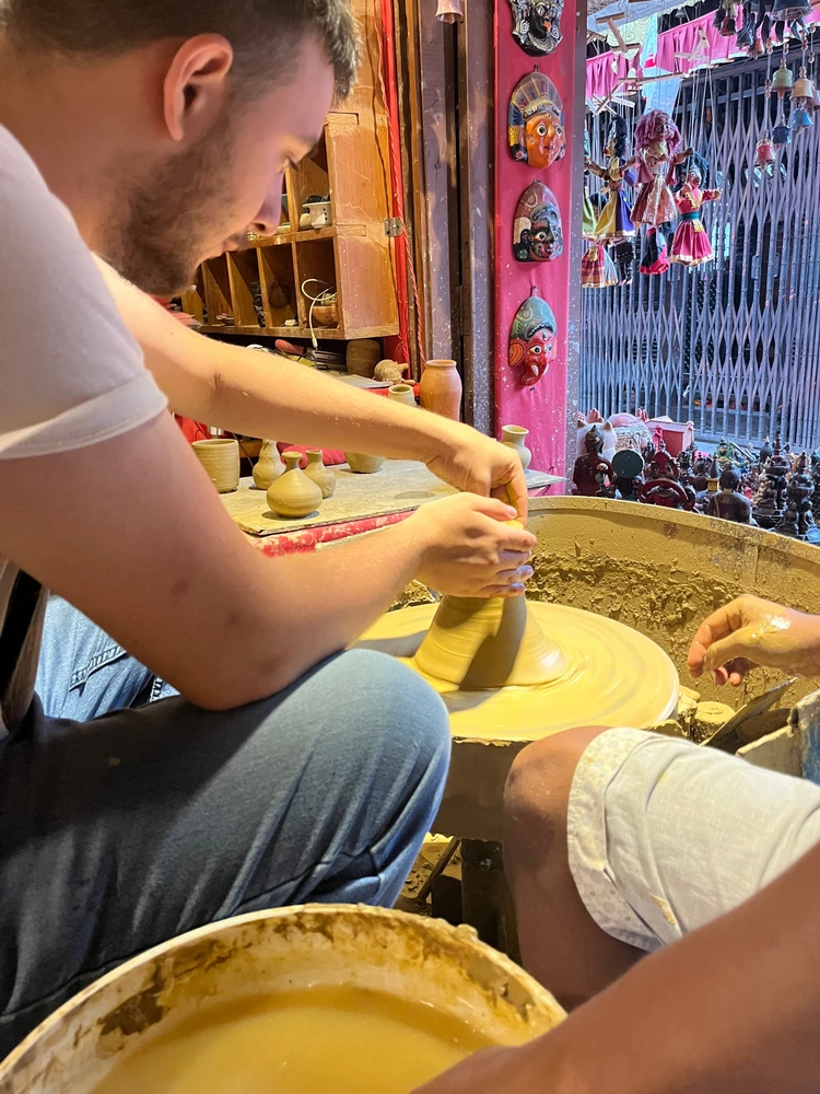 This is a picture of me creating a vase on a pottery wheel in Nepal. It doesn’t look like it yet but it was getting there.