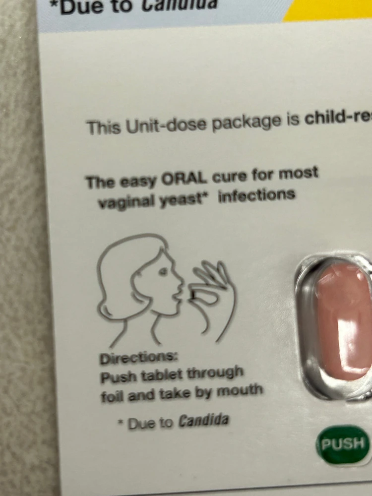 a black outline of a feminine presenting person holding a pill up to their open mount on a pale background