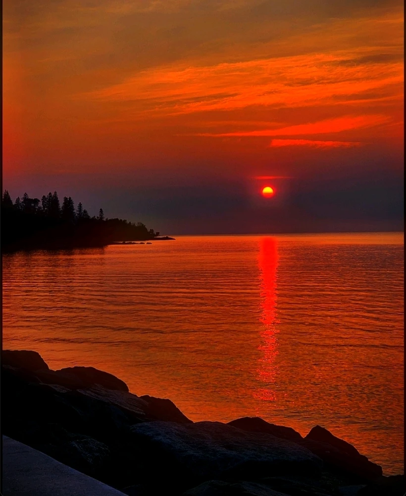 Deep red sunrise over a lake