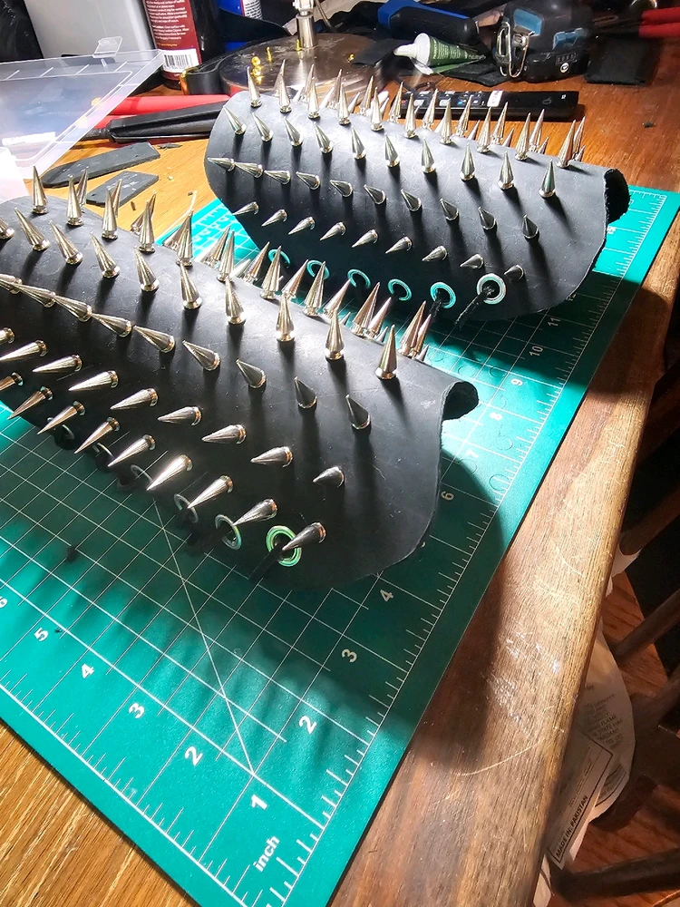 A pair of spiked leather bracers in black.