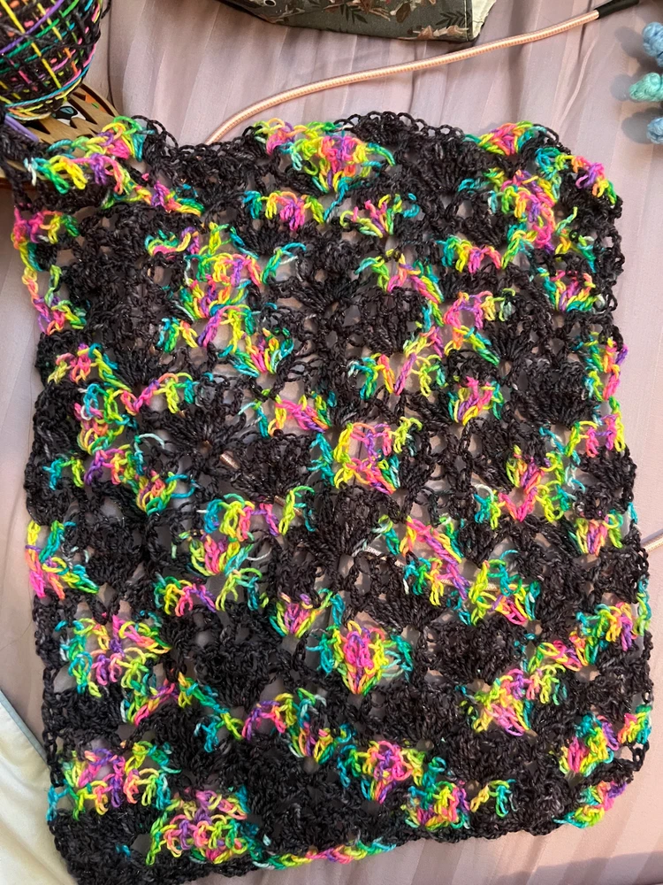 A black and bright rainbow lace yarn pattern that is supposed to turn into a cowl. 