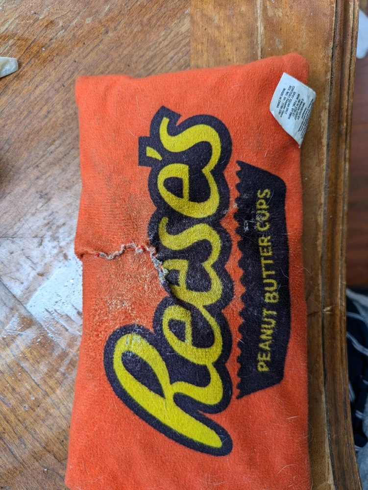 Reese's dog toy with crinkle sound effect ripped and re-stitched