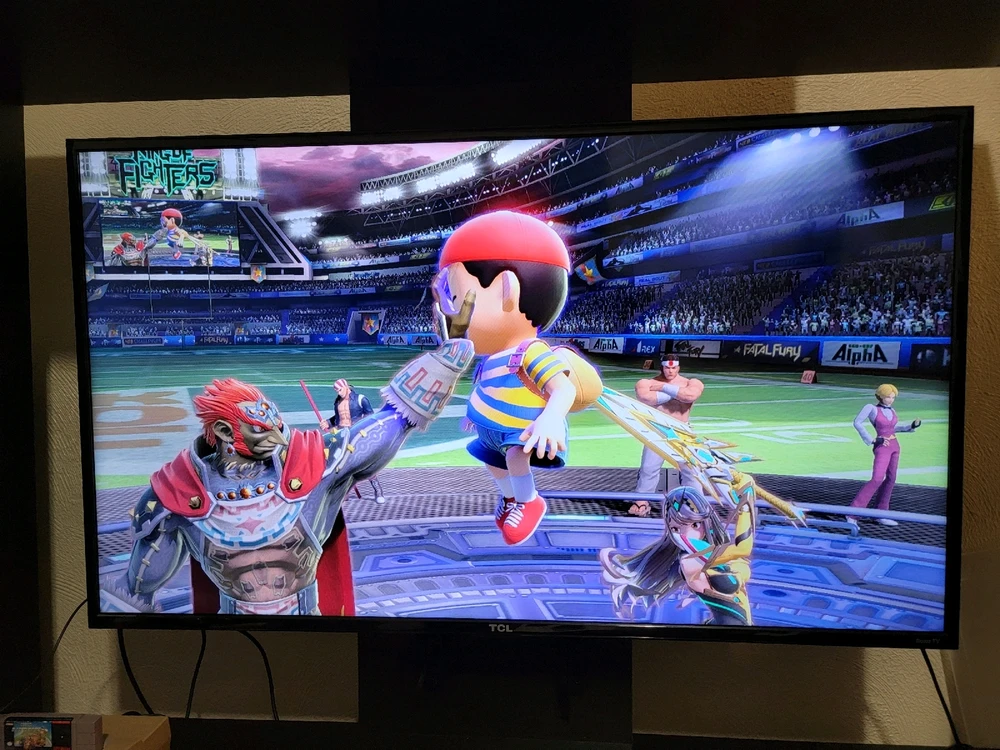 Ganondorf holding Nes up by his giant toddler head while Mythra sticks her sword into his backpack during a Smash bros round.