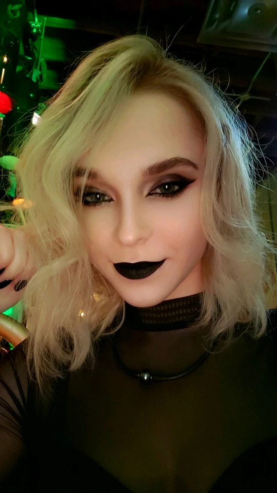 I selfie of a girl with white hair and goth/alt makeup. 