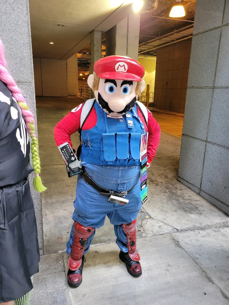 A cosplay of Mario from Super Mario Bros.
His outfit is slightly altered into a more military attire while keeping his colors