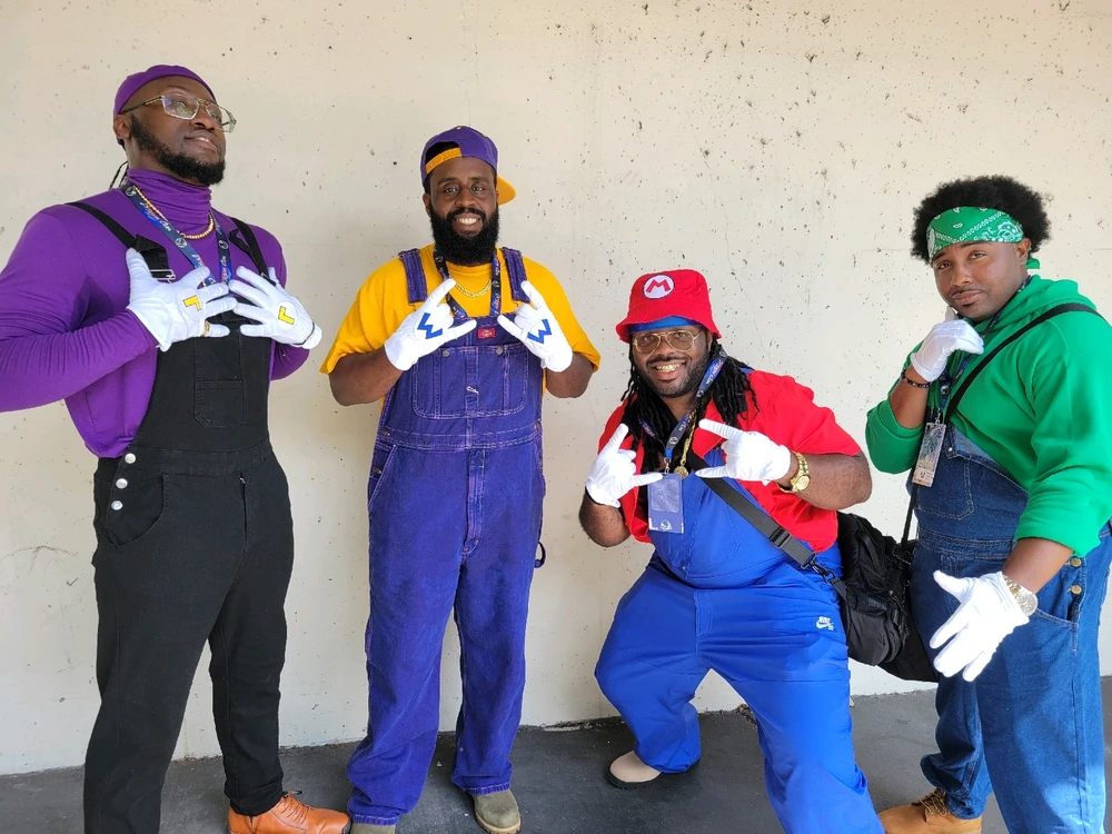 A squad of black men in a cosplay outfit of Mario, Luigi, Waluigi and Wario 