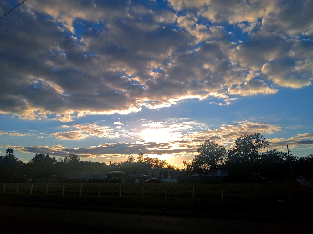 Sunsetting photo, very cloudy and bright. The sun shines through and toasts the clouds!! 