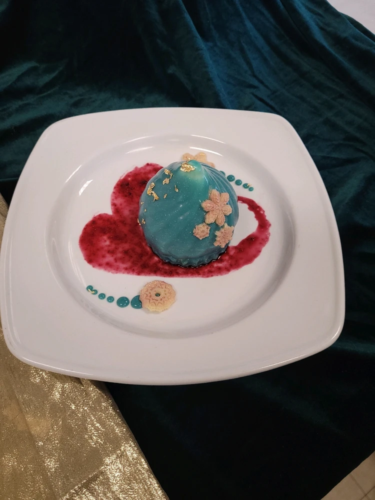 White chocolate & Bavarian cream mousse with ginger apple compote. Black berry Coulis 