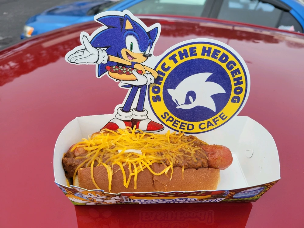 The official Sonic Speed Cafe Chili dog, it is in a container with the Sonic character and logo 