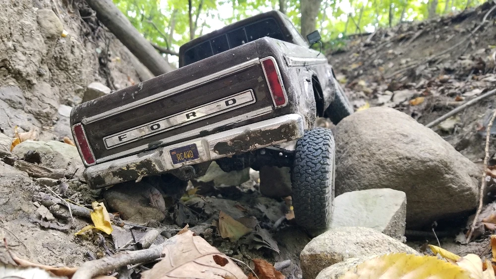 1/10th scale 1979 Ford F150, custom built RC, flexing its suspension in a drainage wash
