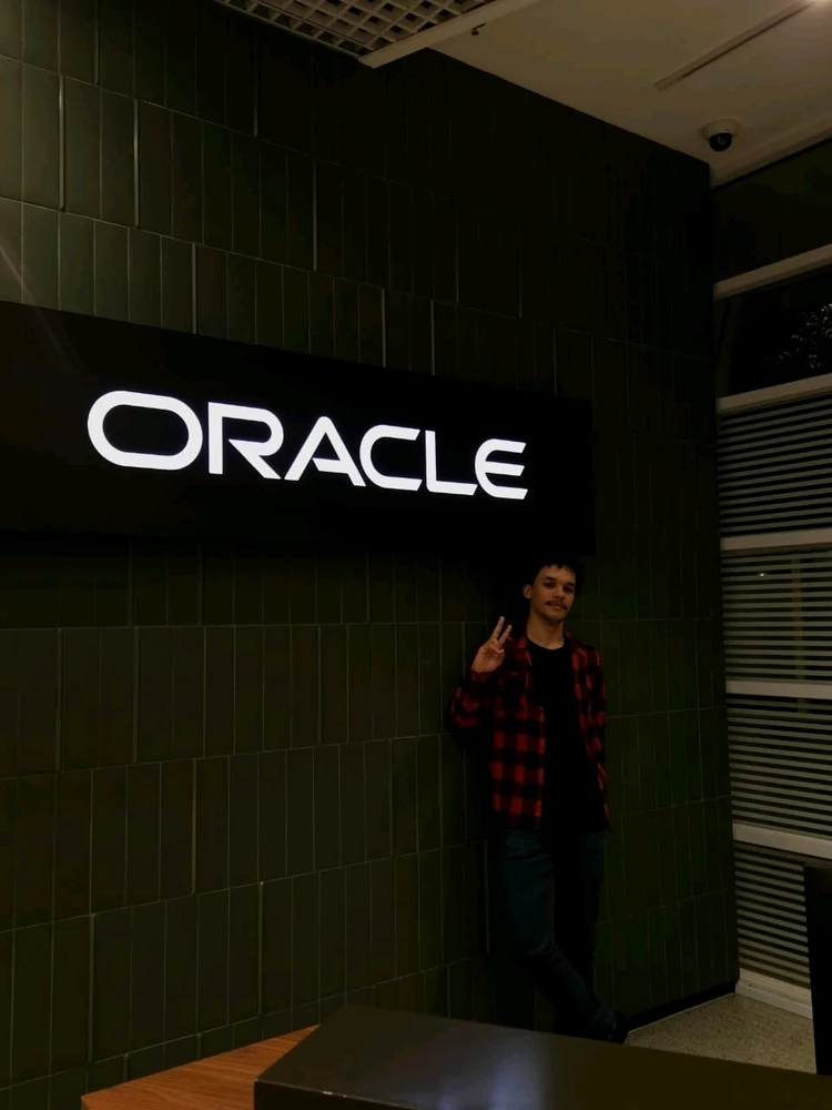 A men with a red and black shirt at the oracle company.