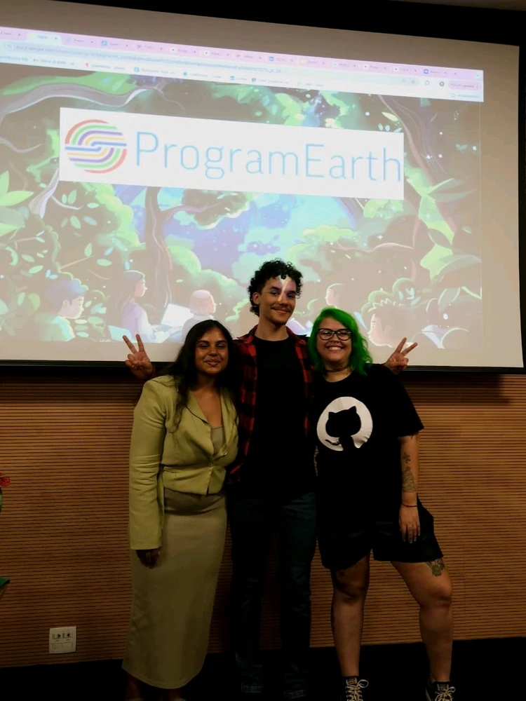 Three people standing in front from the camera. One men and two women.