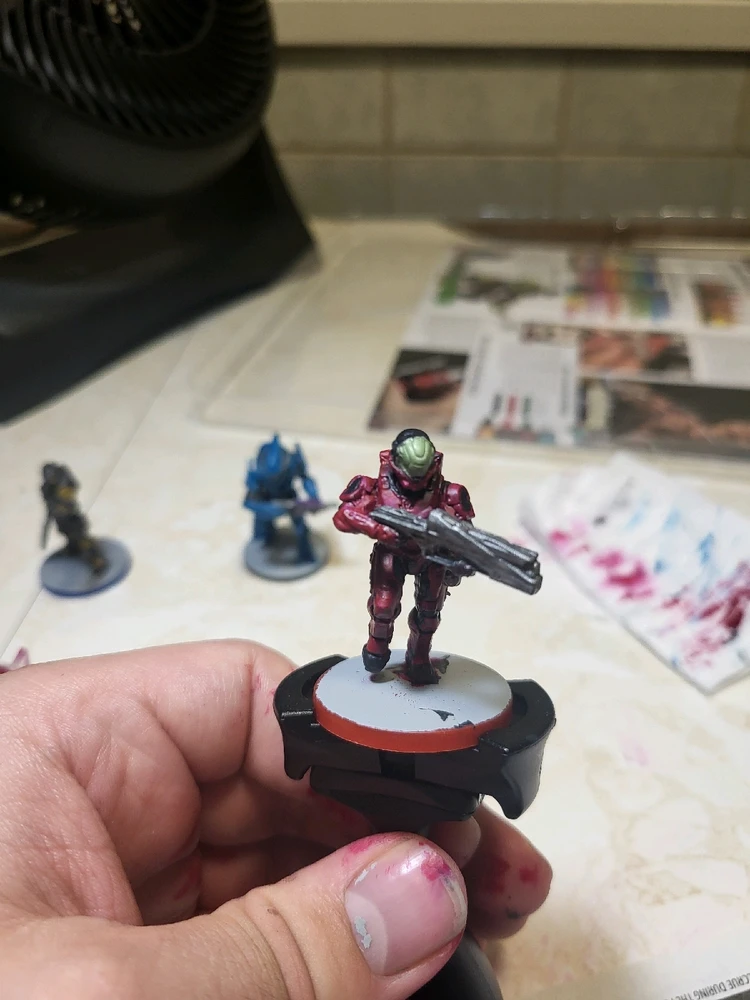 A Spartan Zvezda for Halo Flashpoint holding a launcher and running. This one has been painted pink and blac. From the front.