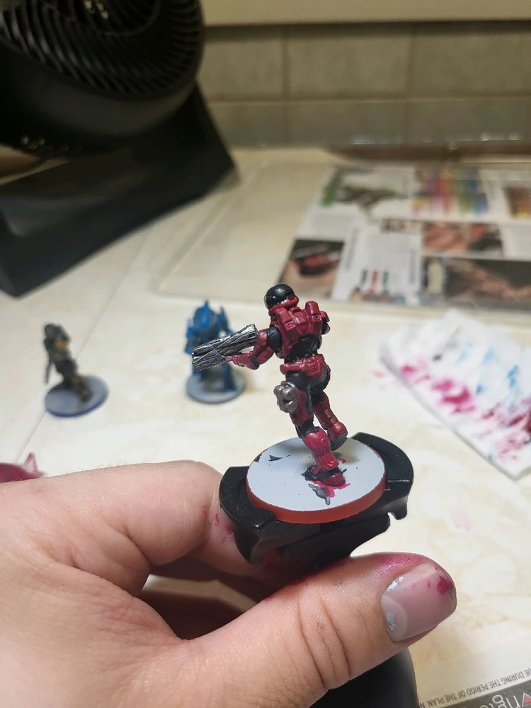 A Spartan Zvezda for Halo Flashpoint holding a launcher and running. This one has been painted pink and blac. From the back.