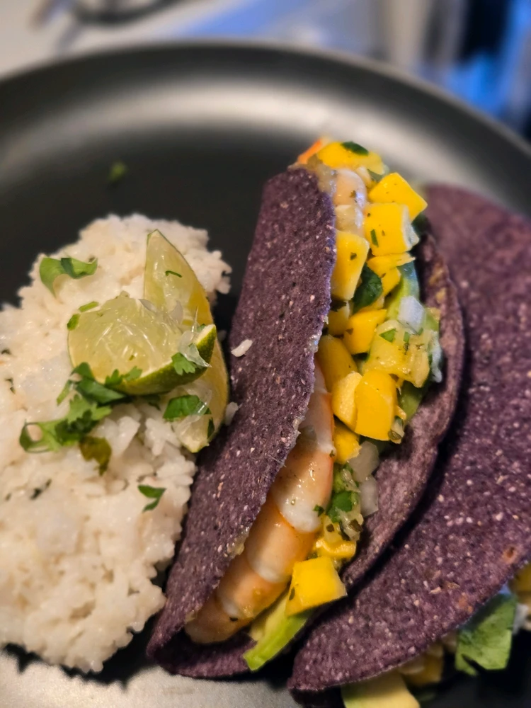 Shrimp tacos with mango pineapple salsa with cilantro lime rice.
