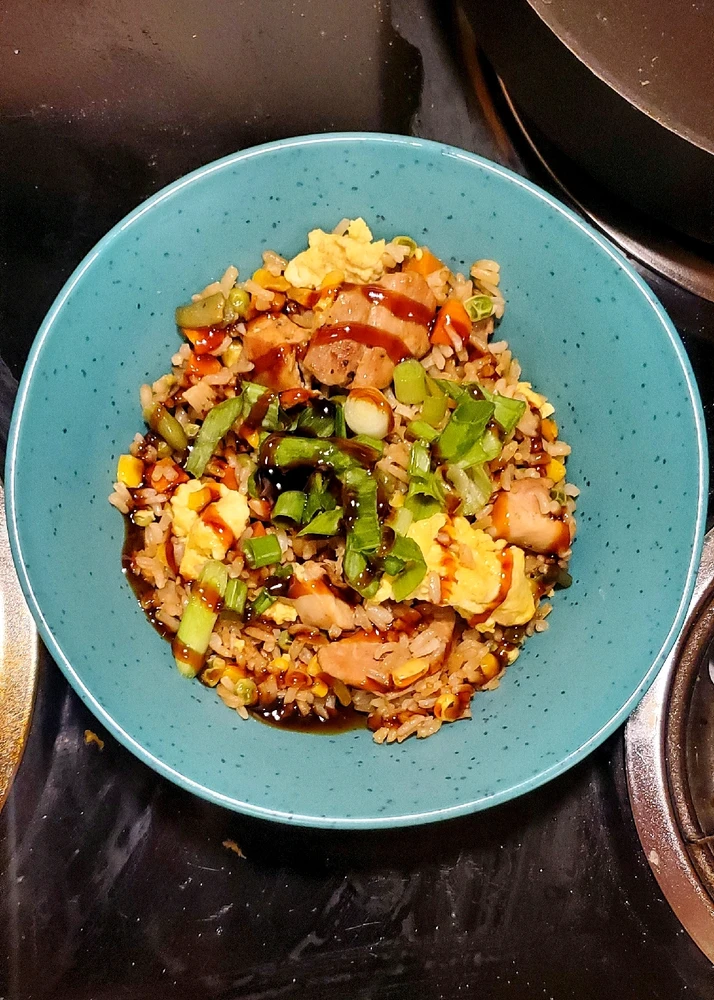 Chicken fried rice with fluffy egg and scallions and eel sauce spiraled over the whole thing. 