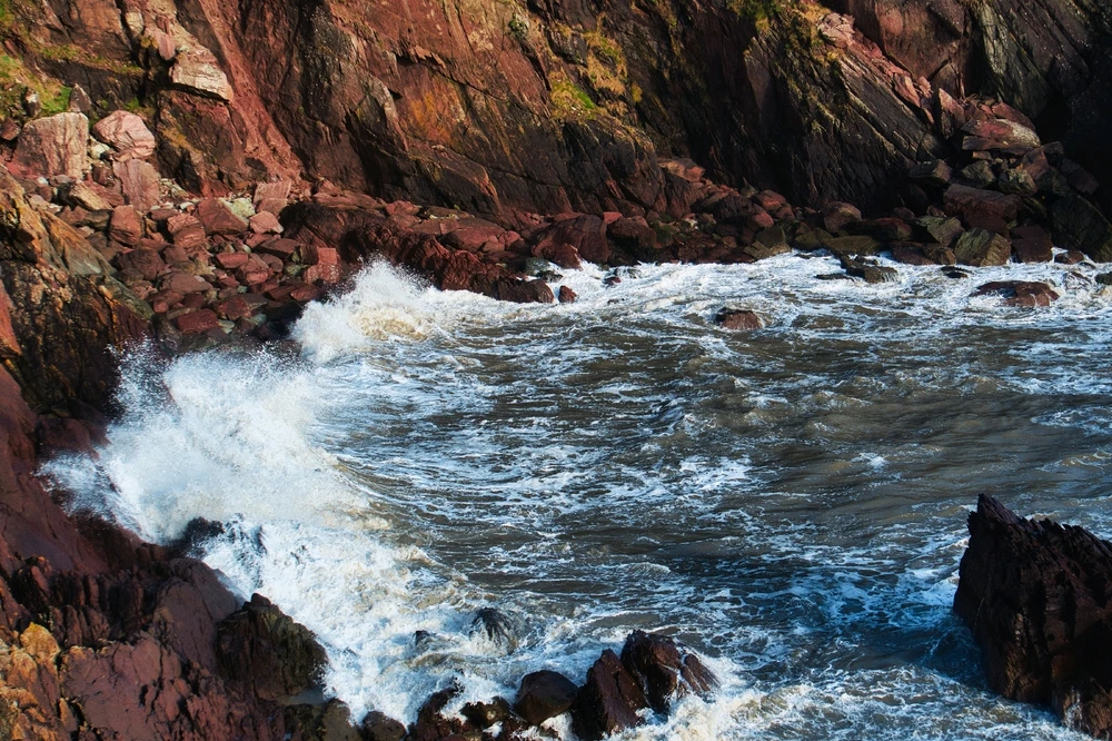Waves washing against a cliff face. 