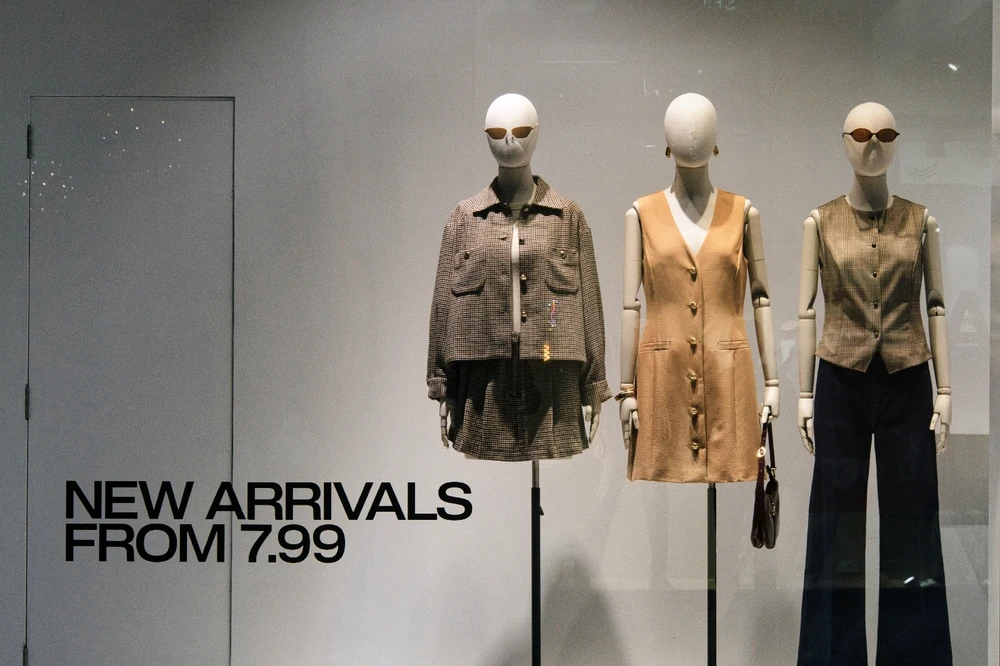 Window display with three outfits on mannequins