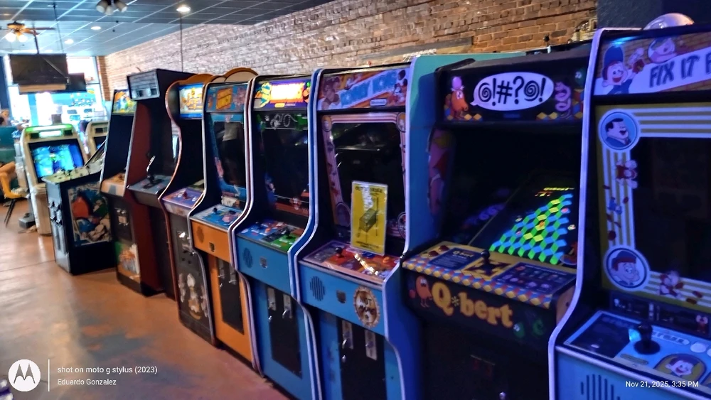 Another row of acrade machines. From the far lefl, Burger Time, Donkey Kong Jr., Mario Bros. Donkey Kong, and Q-Bert