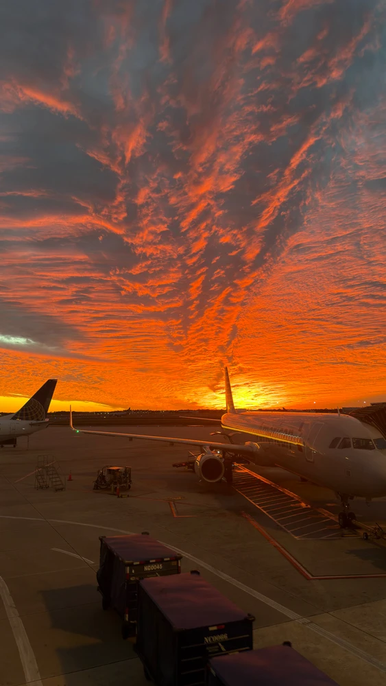 Sunset with large clouds and airplanes