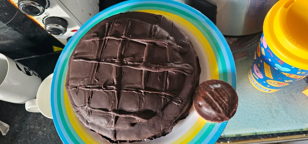 Homemade giant jaffa cake next to a regular size one.