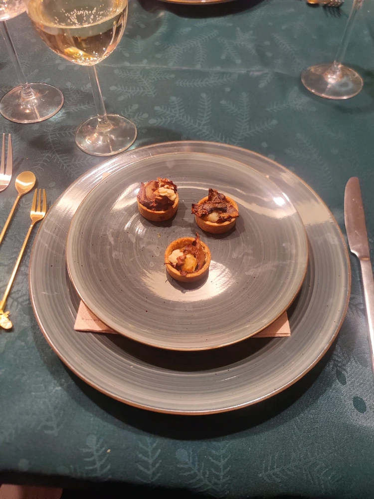 A trio of mushroom & goat cheese tarts topped with Roasted walnut
